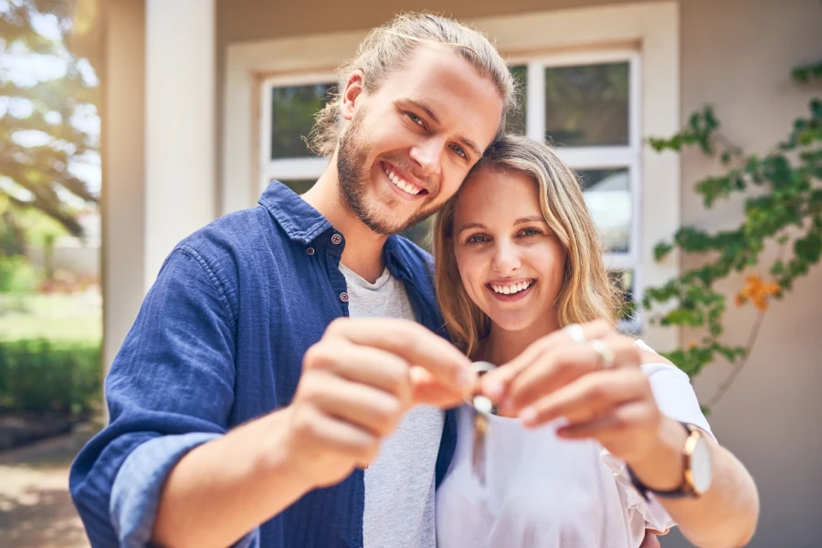 Home buyers holding their new house keys